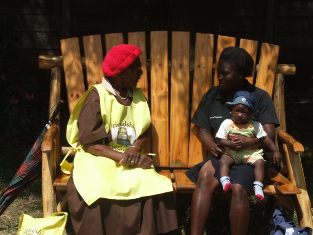 In Zimbabwe, a trained health worker counsels a young mother on the Friendship Bench, through a project supported by Grand Challenges Canada.