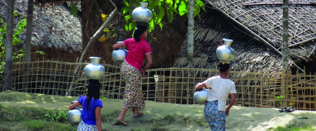 Women carrying water in Myanmar