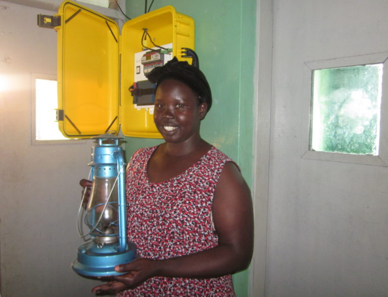 Before the Solar Suitcase, Claire, a midwife, had to rely on a kerosene lamp to provide light in the health facility where she works. Photo courtesy of We Care Solar®