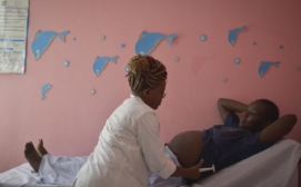 Access Afya Clinical Assistant monitors a pregnant mother in the clinic