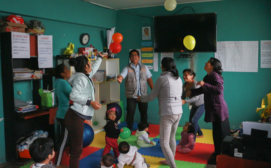 Caregivers perform group dynamic with balloons led by the community health worker during the CASITA educational session