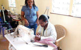 Fashion and design student learns how to operate an industrial machine at the HOPE worldwide Kenya's fashion and design social enterprise