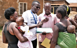 Global Health Economics Ltd - Project member sensitizing young women on the program in the Kifumbira slum community, Kampala, Uganda.