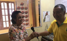 Sciventions - Alroben, the radio host, handing the mic to the project lead, Dr. Erlindah Goh