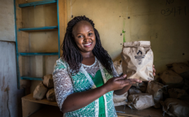 Sanivation employee sells charcoal briquettes as a part of a women-led sales approach
