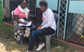 A Bold Idea for Girls assistant interviews a project participant during recruitment activity (Dandora, Nairobi)